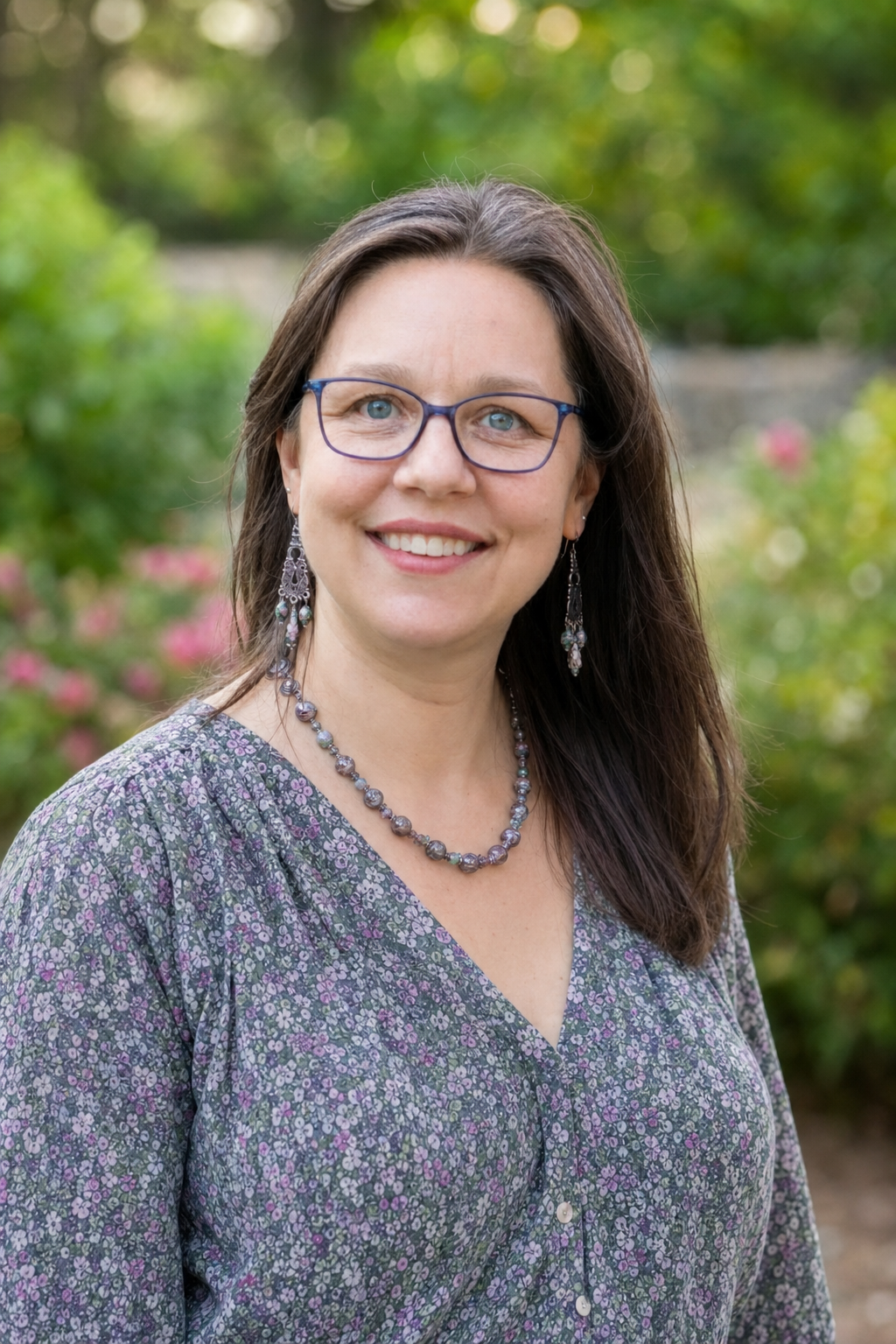 Portrait of Dr. Erika A. Taylor smiling outdoors in a garden